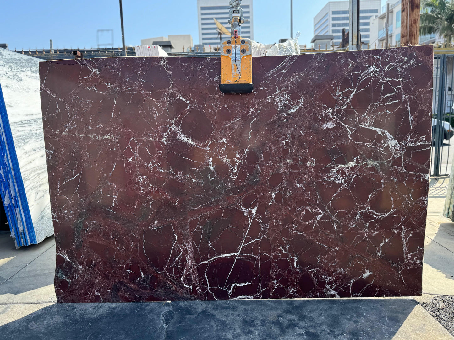Marble slab with a maroon and white pattern in los angeles stone yard