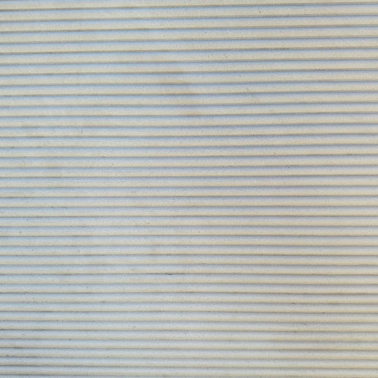 Details of beige fluted limestone slab in stock in Los Angeles slab yard