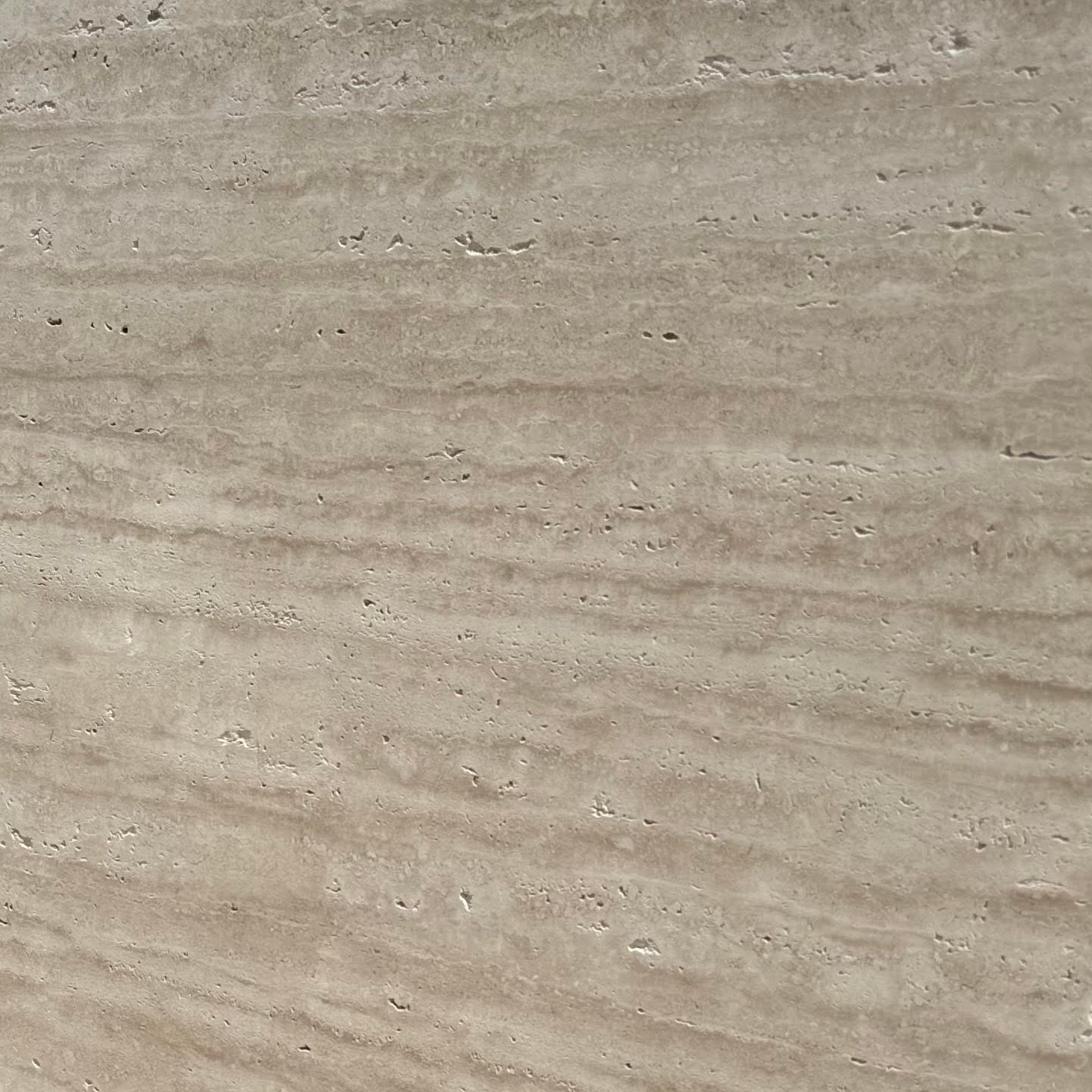 Large travertine stone slab with a textured surface, used for flooring or landscaping.