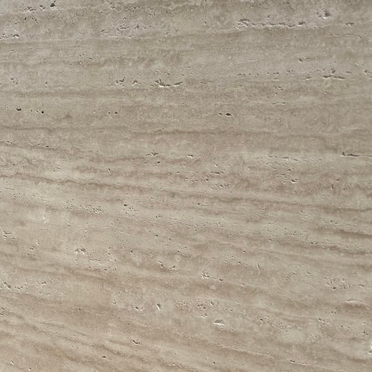Large travertine stone slab with a textured surface, used for flooring or landscaping.